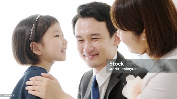 Young asian girl and mother holding heart symbol