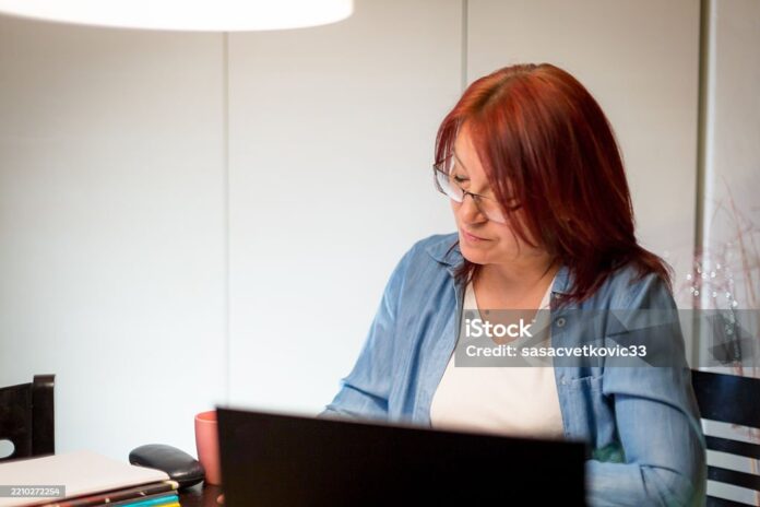 The teacher is organizing notes and reviewing lessons at home