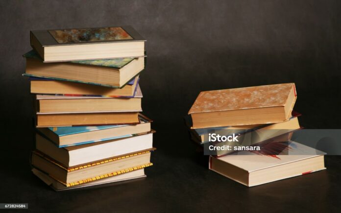 Two piles of books in different bindings in studio